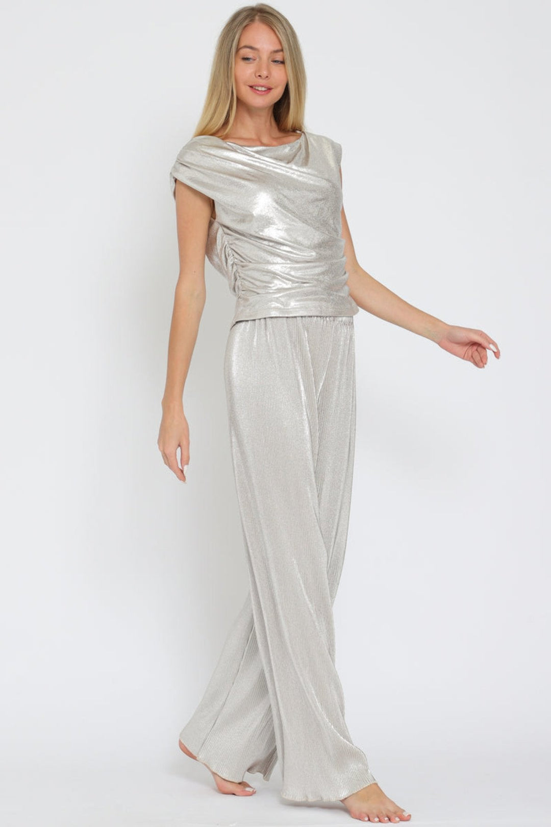 Eye-catching silver metallic set with a shiny texture and elegant cowl neck, perfect for any stylish occasion. 