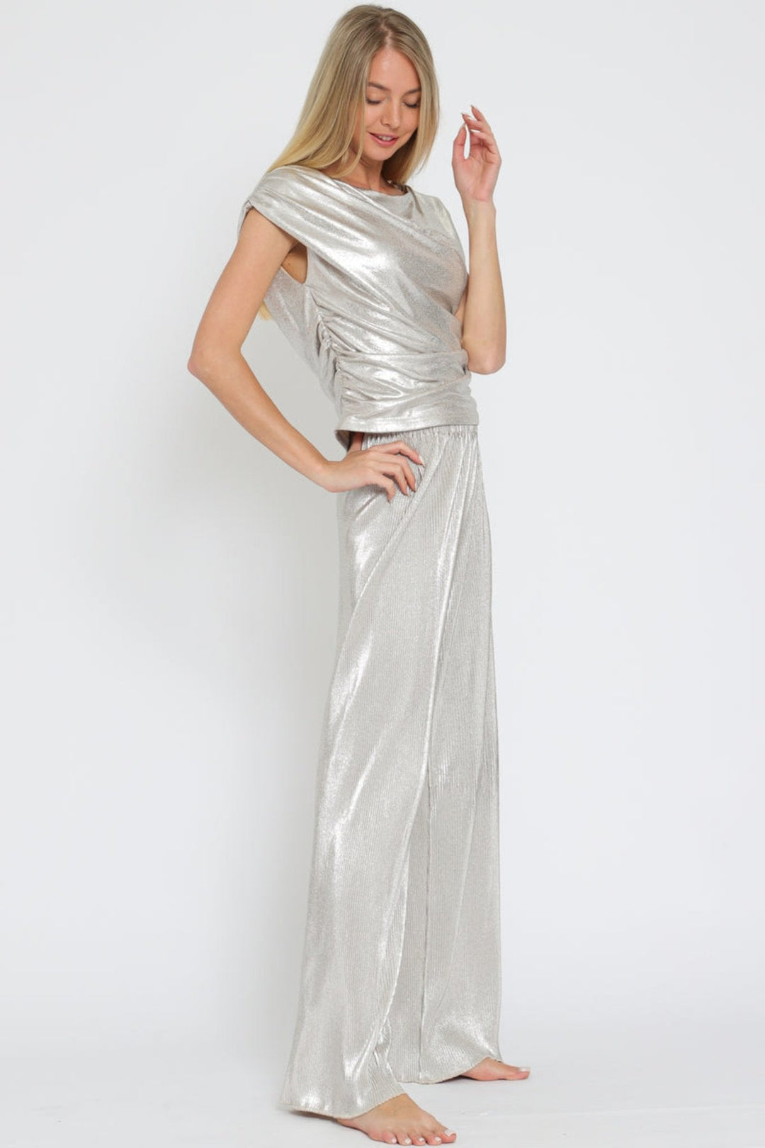 Eye-catching silver metallic set with a shiny texture and elegant cowl neck, perfect for any stylish occasion. 