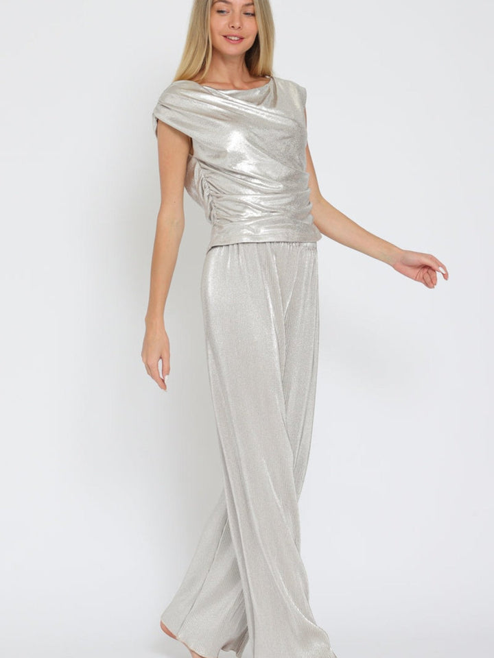 Eye-catching silver metallic set with a shiny texture and elegant cowl neck, perfect for any stylish occasion. 