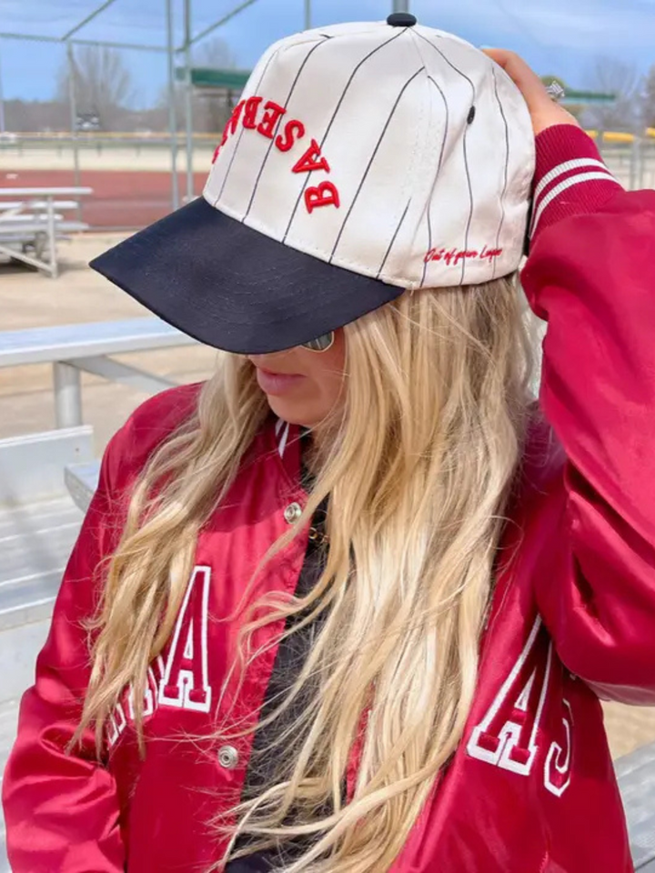 Stylish woman wearing the KENZKUSTOMZ - Baseball Stripe Trucker Hat with bold stripes and a vintage look.