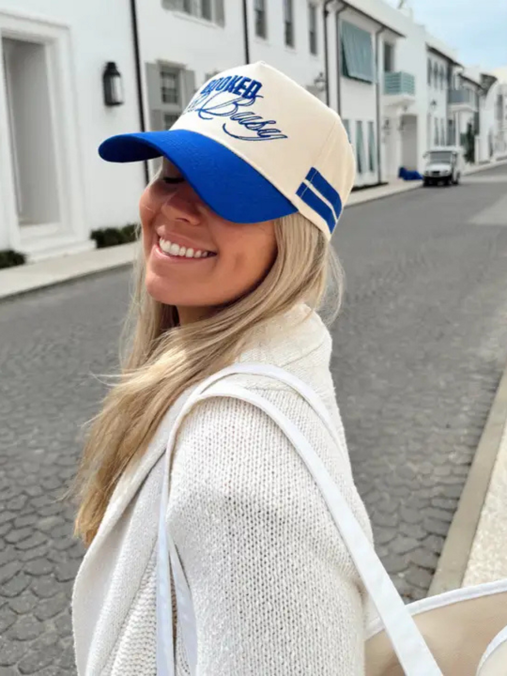 Stylish model wears the KENZKUSTOMZ - Booked and Busy Vintage Trucker Hat, showcasing its bold royal blue design.