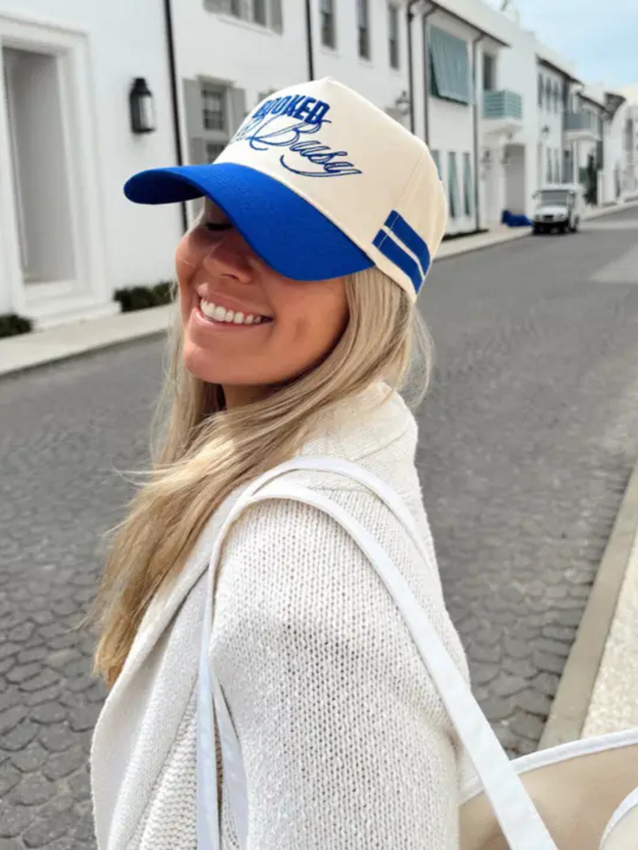 Stylish model wears the KENZKUSTOMZ - Booked and Busy Vintage Trucker Hat, showcasing its bold royal blue design.