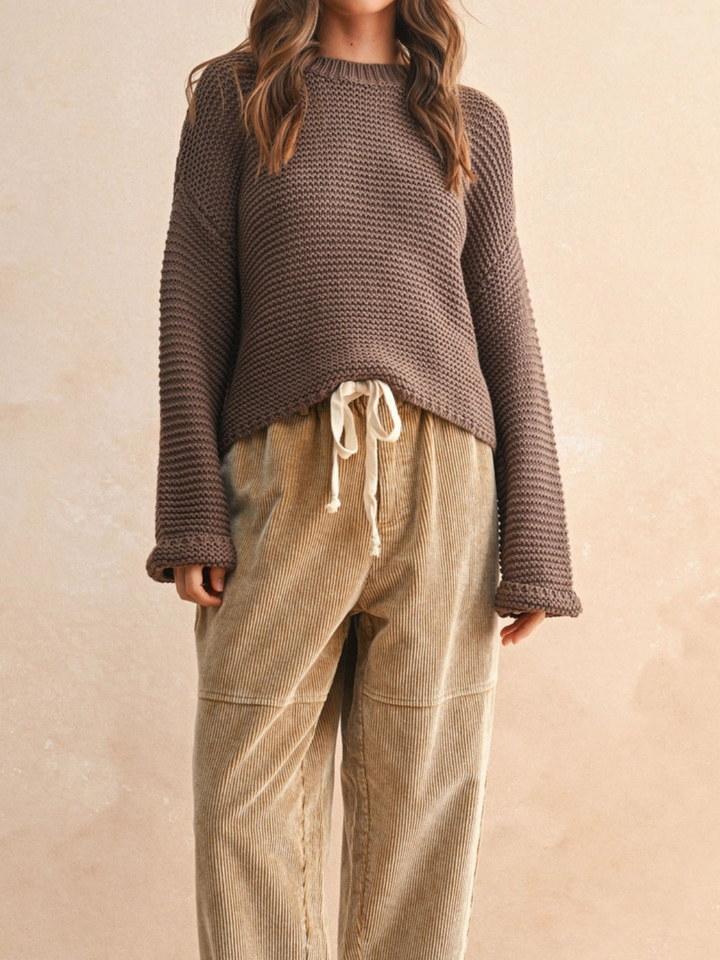 Laid-Back Luxe Chunky Knit Top in brown, relaxed oversized fit with round neckline; paired with beige corduroy pants.