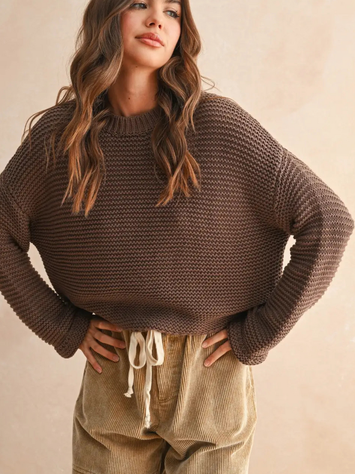 Laid-Back Luxe Chunky Knit Top in brown with relaxed oversized fit and round neckline, shown with beige corduroy pants.