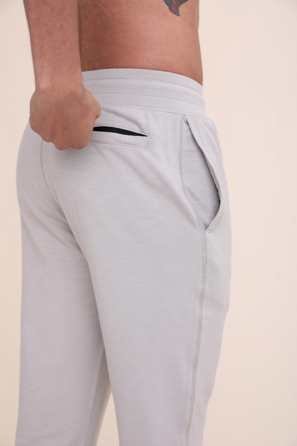 Keep it simple with these elevated joggers. They have a drawstring waistband, single zipper back pocket, and a stitch part way up the back of the legs.