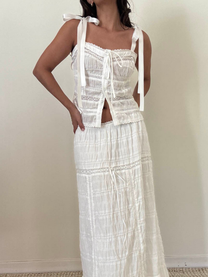 The Meadow Muse Sweetheart Tie-Strap Top features a charming design with ribbon ties, perfect for summer outings.