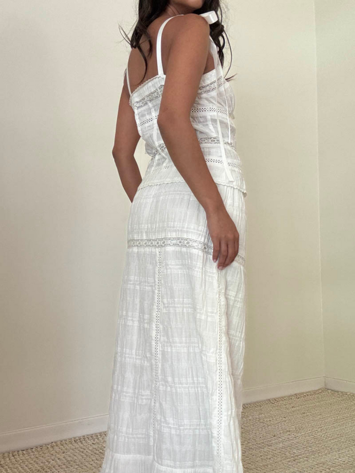 Stylishly showcase the Meadow Muse Sweetheart Tie-Strap Top with its charming design and flowy summer-ready look.
