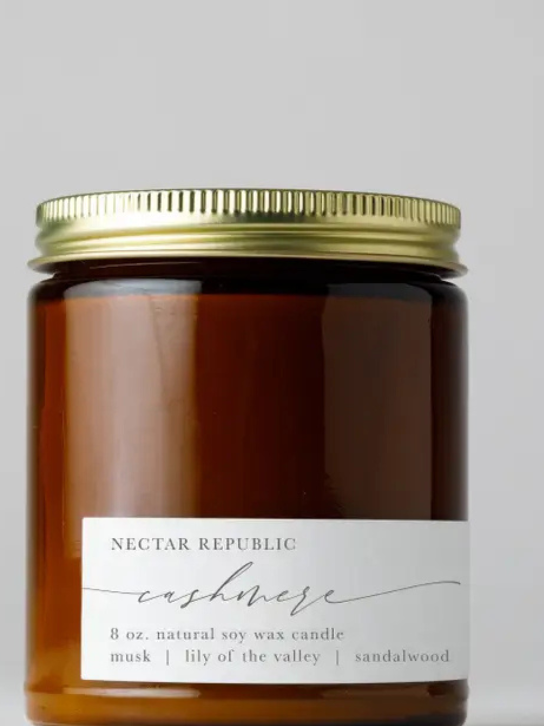 NECTAR REPUBLIC Cashmere 8 oz soy wax candle in amber jar with gold lid; musk, lily of the valley, sandalwood.