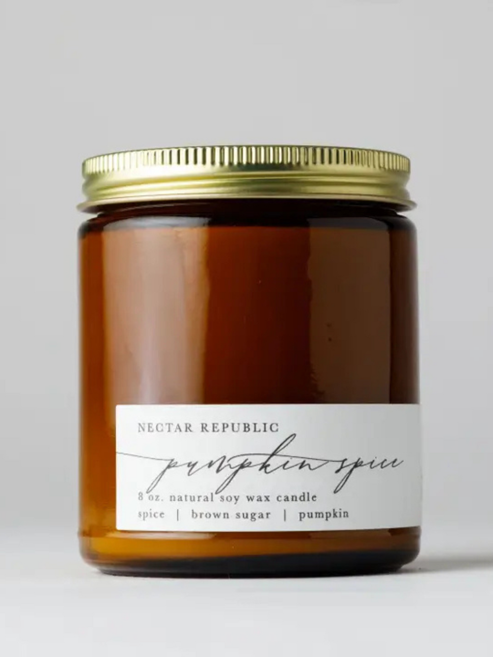 Amber jar soy candle with gold lid, Nectar Republic Pumpkin Spice 8 oz label.