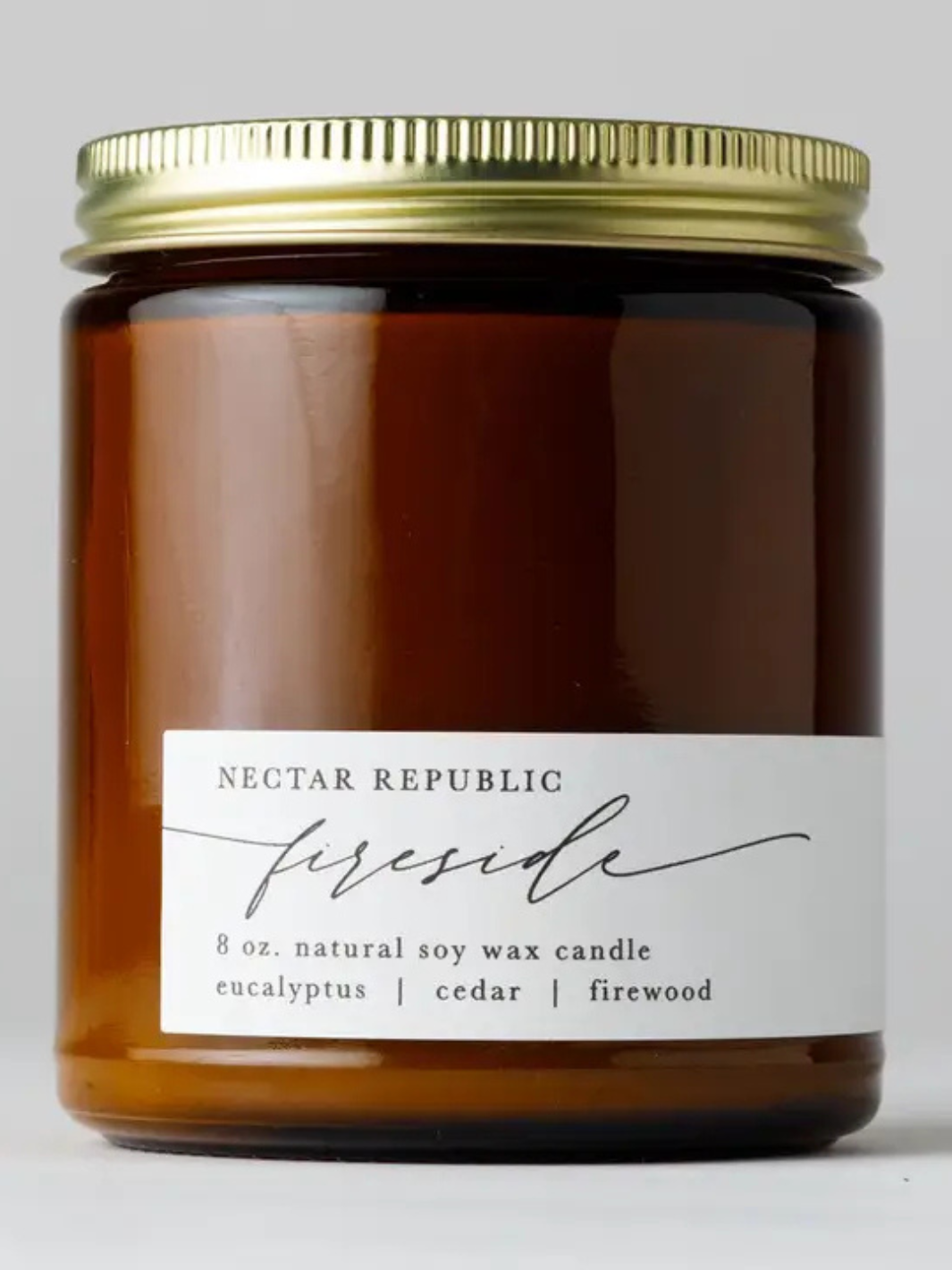 Nectar Republic Fireside 8 oz soy candle in amber jar with eucalyptus, cedar, and firewood scent.