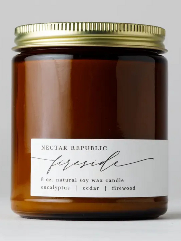 Nectar Republic Fireside 8 oz soy candle in amber jar with eucalyptus, cedar, and firewood scent.