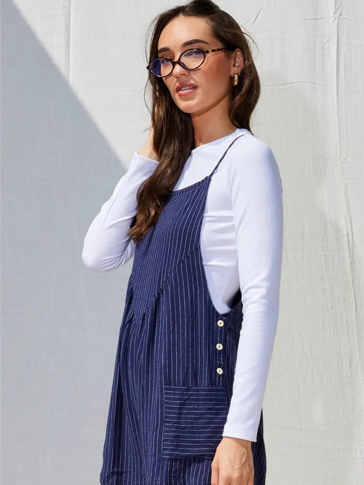 Stylish woman showcasing the Northwest Striped Linen Pocketed Romper, perfect for effortless summer outings.