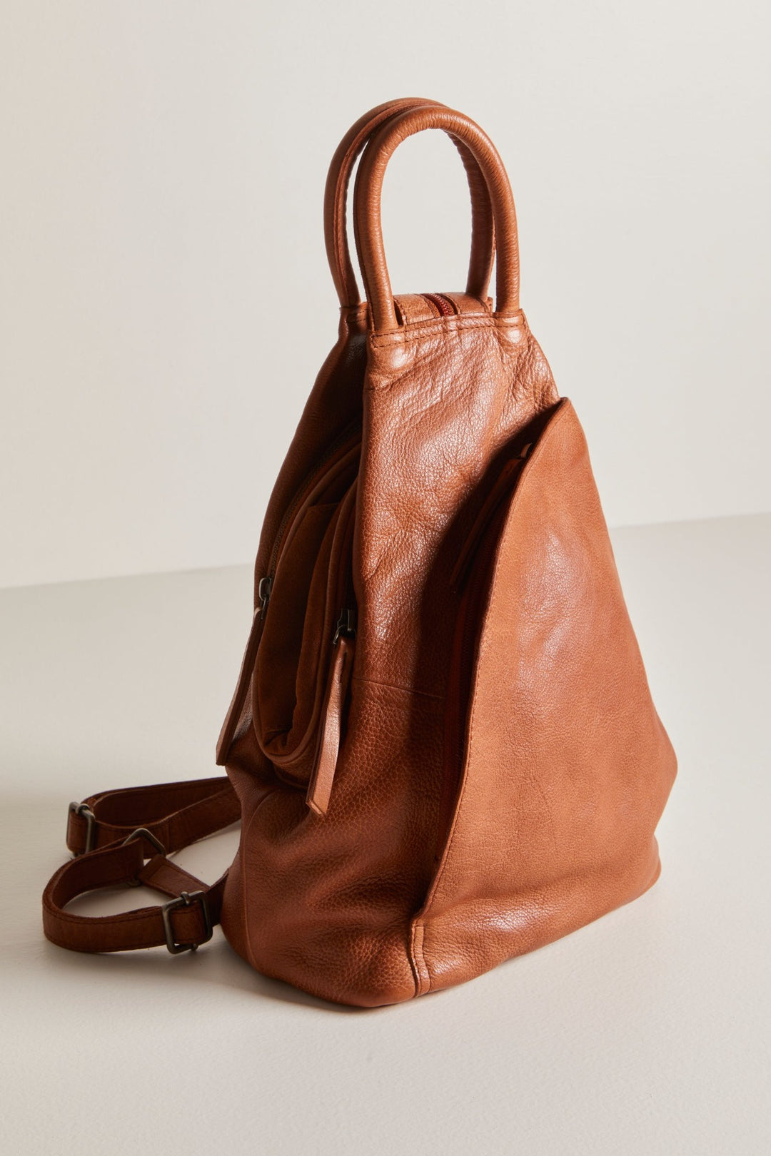 Make a statement wherever you go with the Free People WTF Soho Convertible Leather Bag! This bag is like a chameleon, quickly converting from a stylish sling bag to an edgy backpack with adjustable straps and zipper closures. And you'll look cool no matter how you wear it. Your style just leveled up!