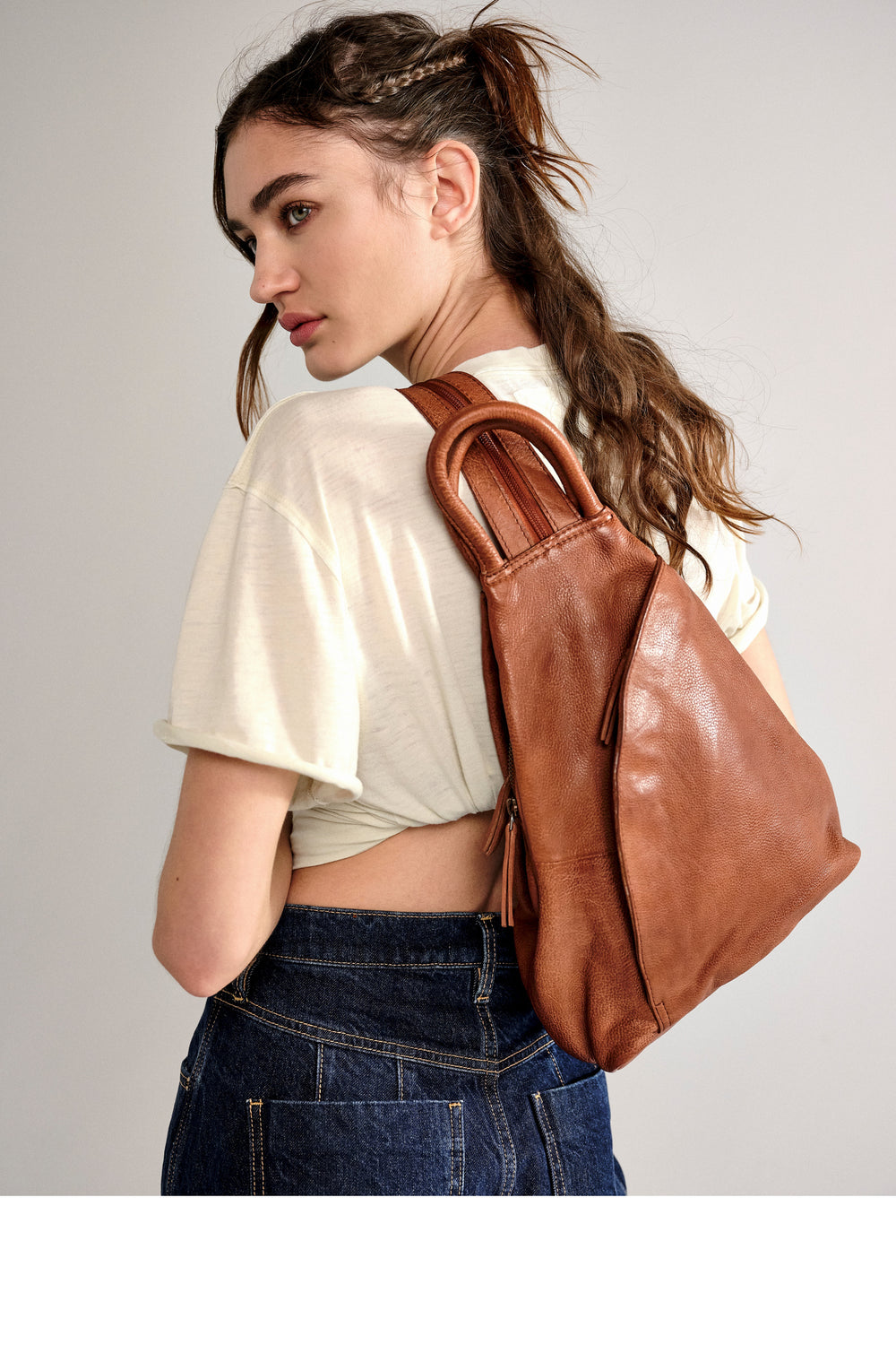 Make a statement wherever you go with the Free People WTF Soho Convertible Leather Bag! This bag is like a chameleon, quickly converting from a stylish sling bag to an edgy backpack with adjustable straps and zipper closures. And you'll look cool no matter how you wear it. Your style just leveled up!
