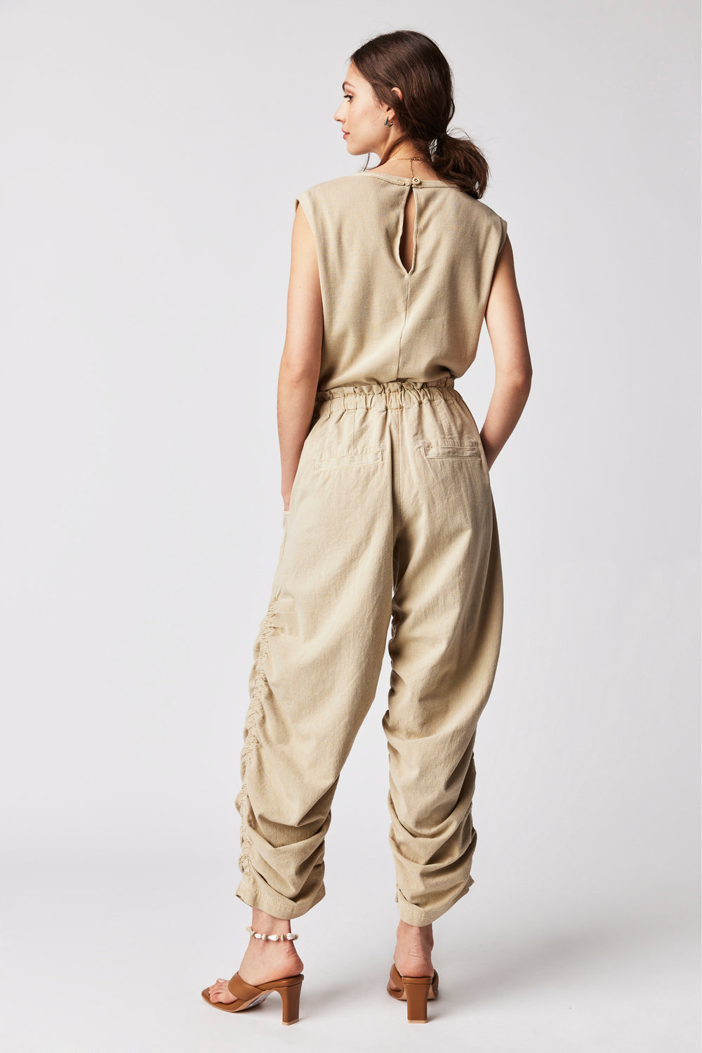 Rock your wardrobe game with this chic, funky one-piece jumpsuit from Free People! Styled with tank sleeves, ruched sides, drawstring, and pockets, this look is the perfect mix of style and comfort. So grab it, show some Sand Jam attitude, and hit the streets!