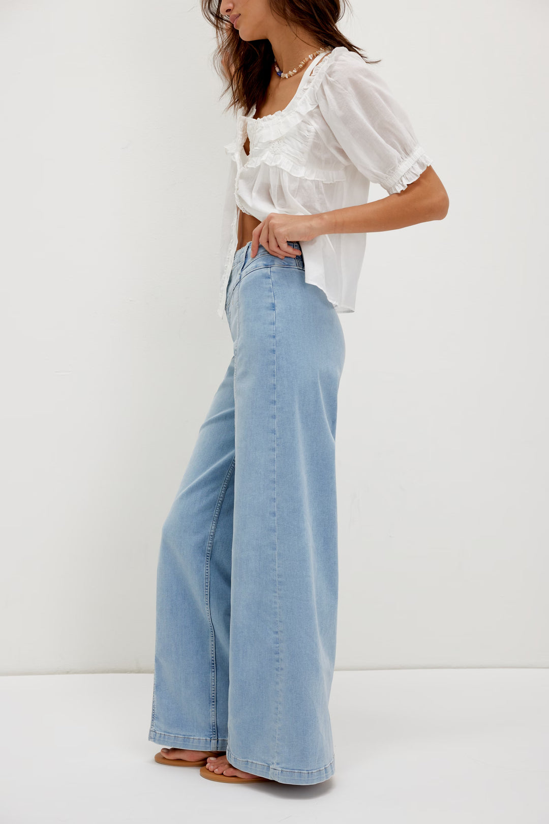 FREE PEOPLE Libre Wide Leg Jeans in light wash with high-rise and seamed panels on a model.