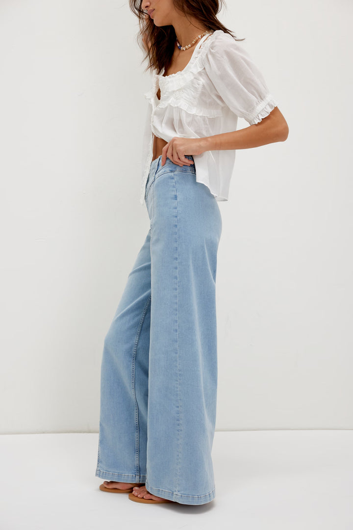 FREE PEOPLE Libre Wide Leg Jeans in light wash with high-rise and seamed panels on a model.