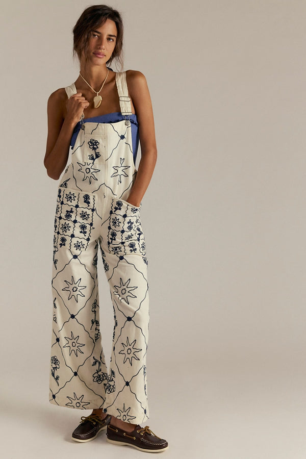 FREE PEOPLE Rising Sun Overall: cream embroidered overalls with navy sun motifs, relaxed bib-and-brace silhouette.