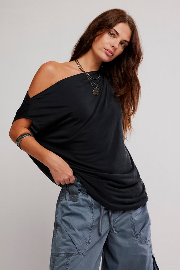Model wearing a black off-the-shoulder Cascadia Tunic draped top with a relaxed fit.