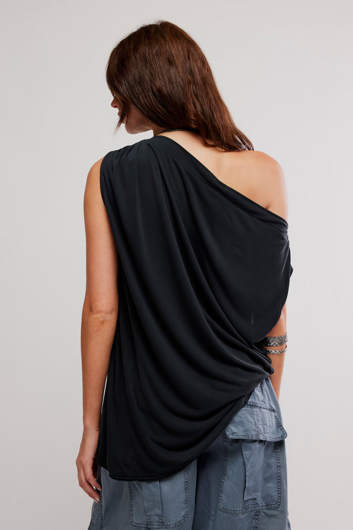 FREE PEOPLE Cascadia Tunic: black draped one-shoulder top, back view on model in soft jersey fabric.