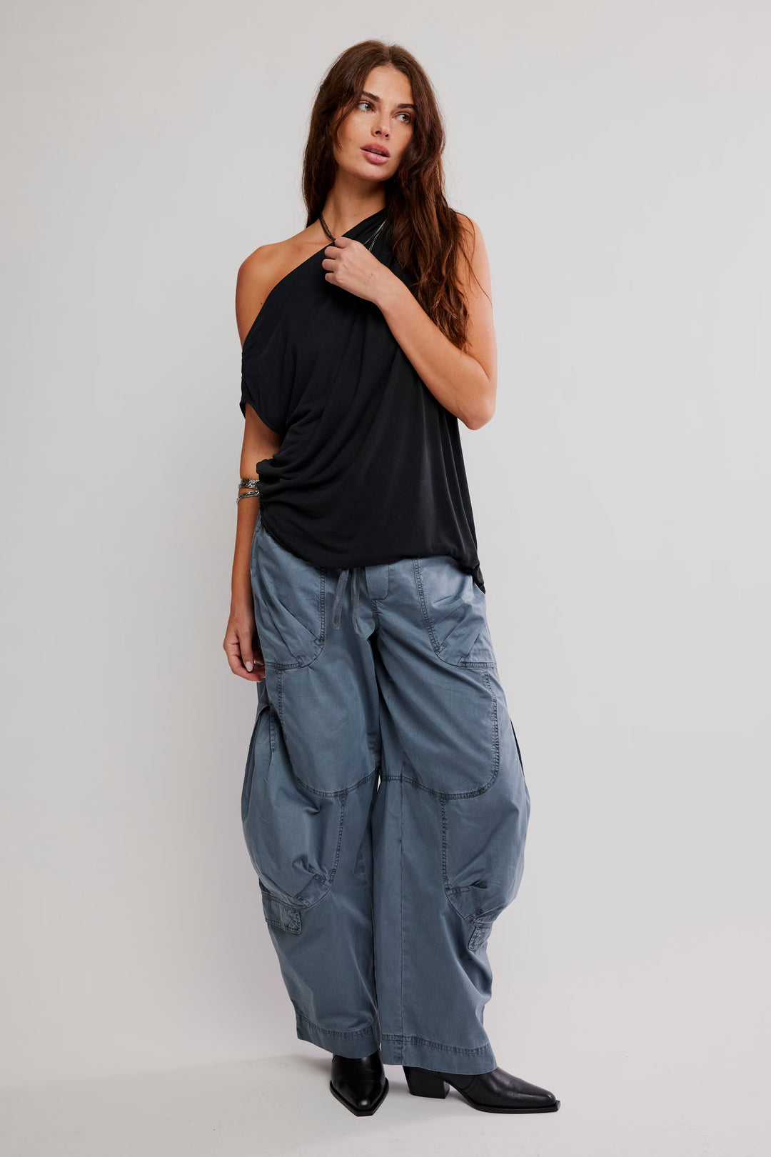 Free People Cascadia Tunic off-the-shoulder draped black top on model.