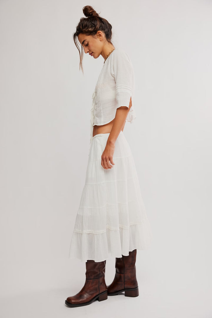 Free People Bright Side Top in white, tie-front, flowy with embroidery, paired with a tiered skirt and brown boots.