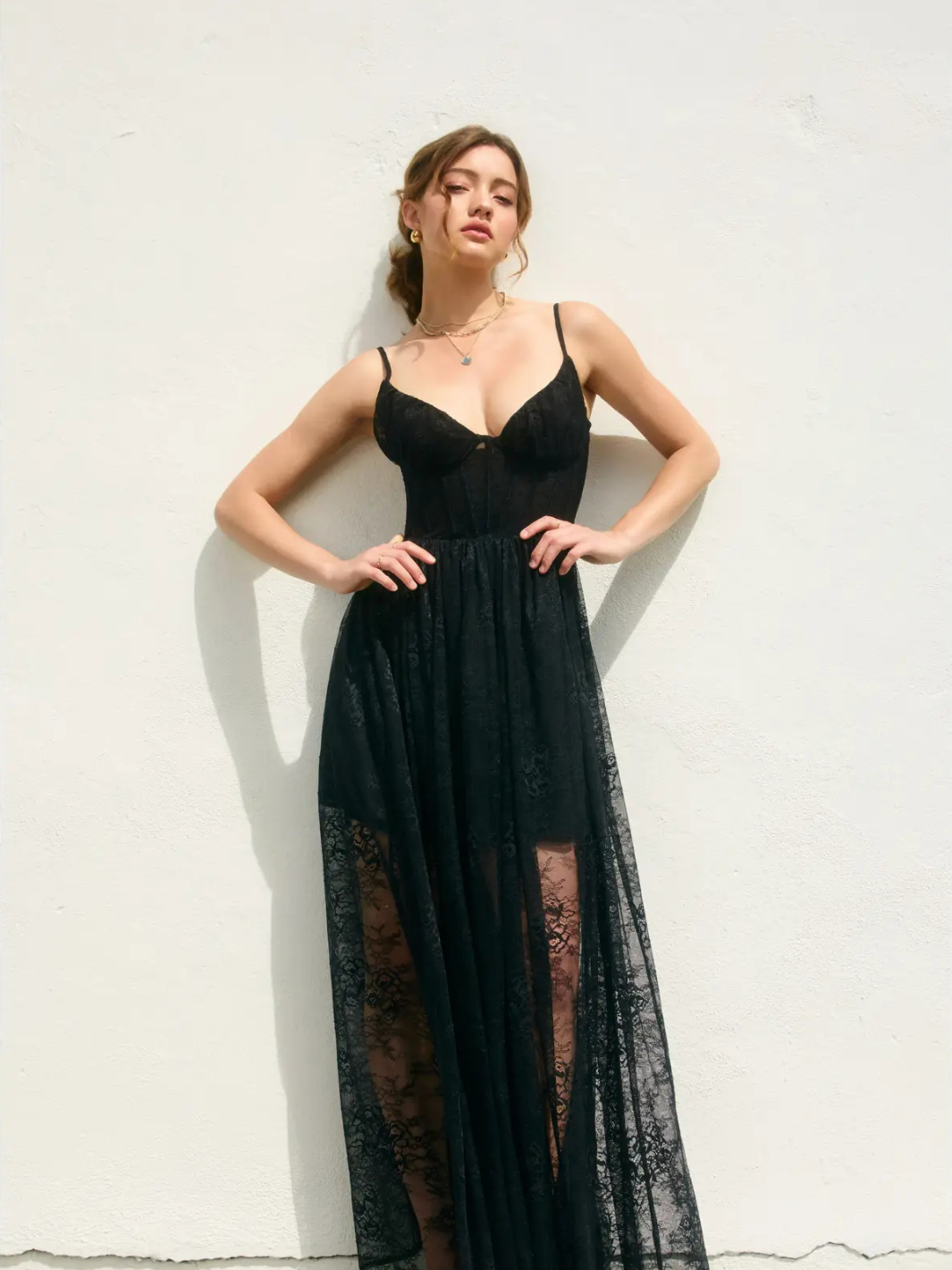 Elegant model showcasing the She Is Radiance Corset Maxi Dress, featuring corset detailing and a flowing chiffon silhouette.