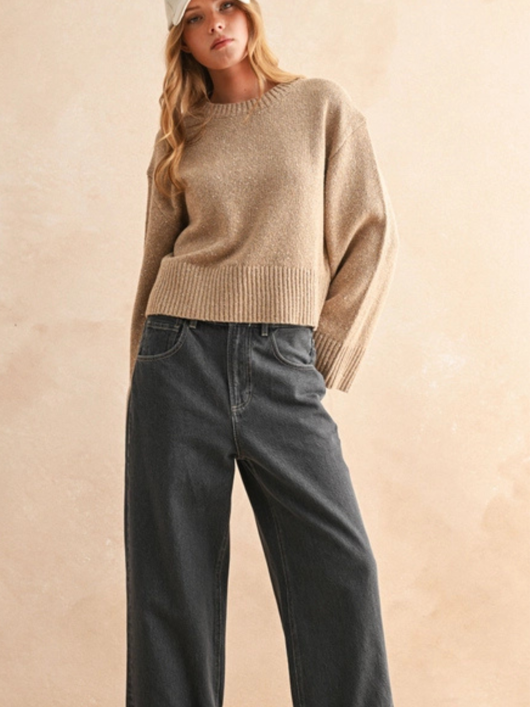 Beige Sprinkled Effect Sweater with relaxed fit, ribbed hem and cuffs, paired with dark jeans.