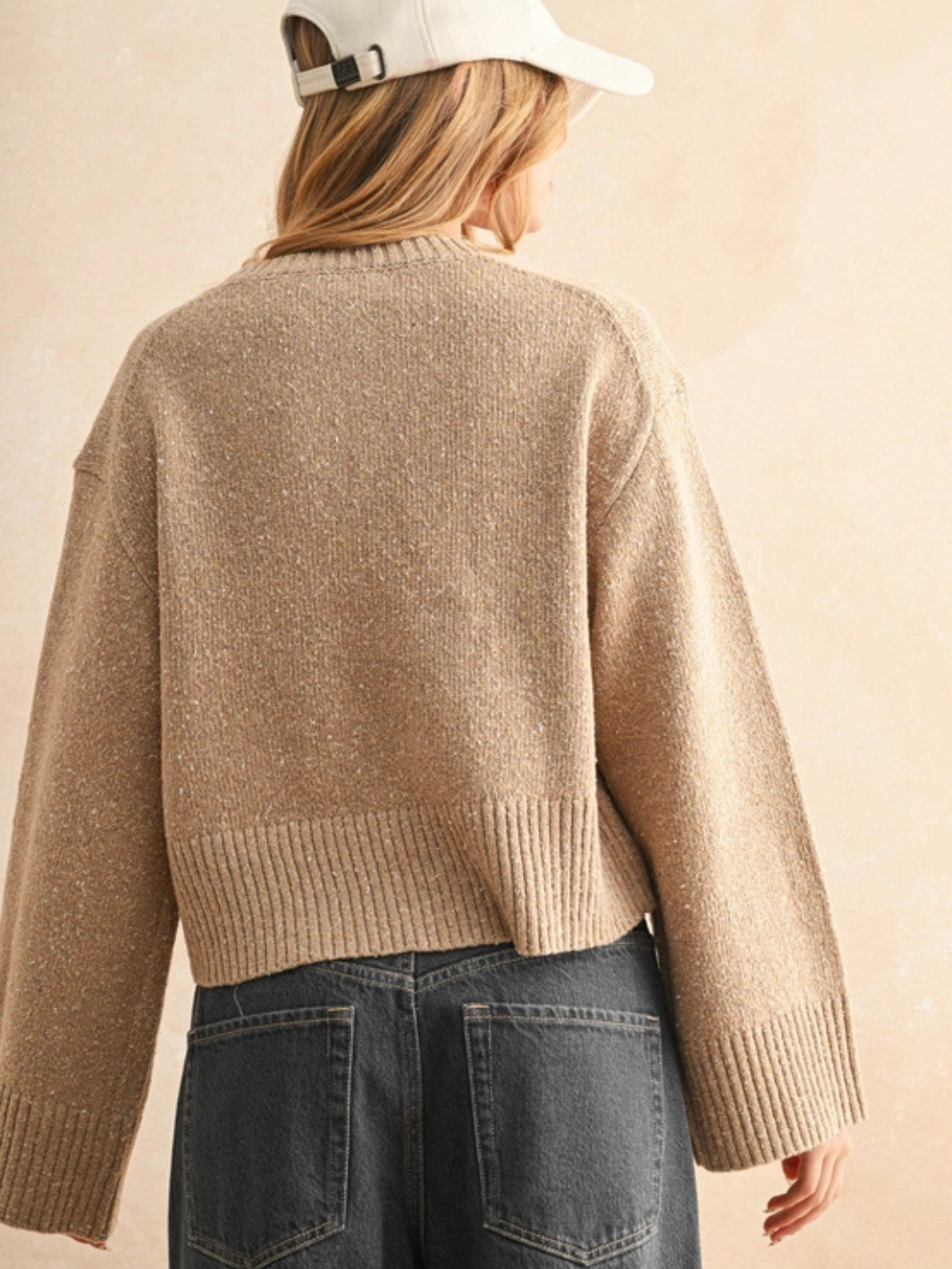 Back view of beige Sprinkled Effect Sweater with relaxed fit and subtle shimmer, speckled knit, paired with jeans.