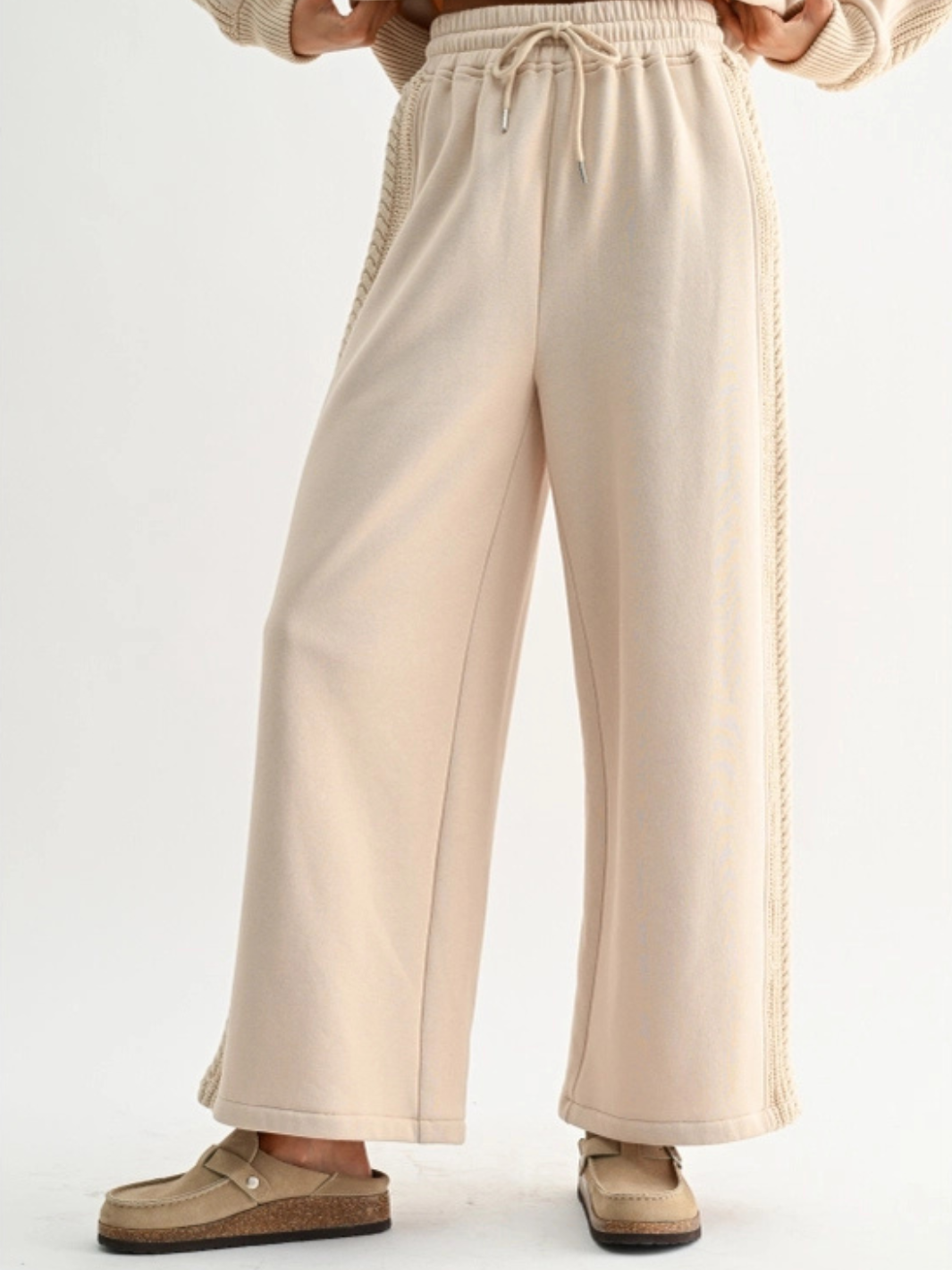 Beige Aria Cable Knit Wide Leg Pant with drawstring waist and cable-knit side panels.