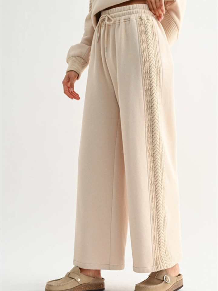 The Aria Cable Knit Wide Leg Pant in beige with side cable-knit trim, drawstring waist, plush lounge comfort.
