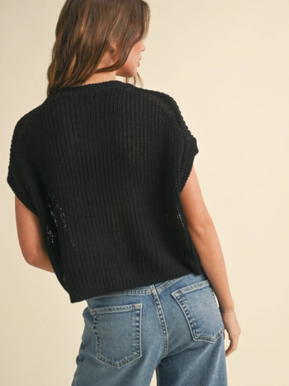 The Capsule Knit Sleeveless Sweater Top in black knit, relaxed boxy fit, back view.