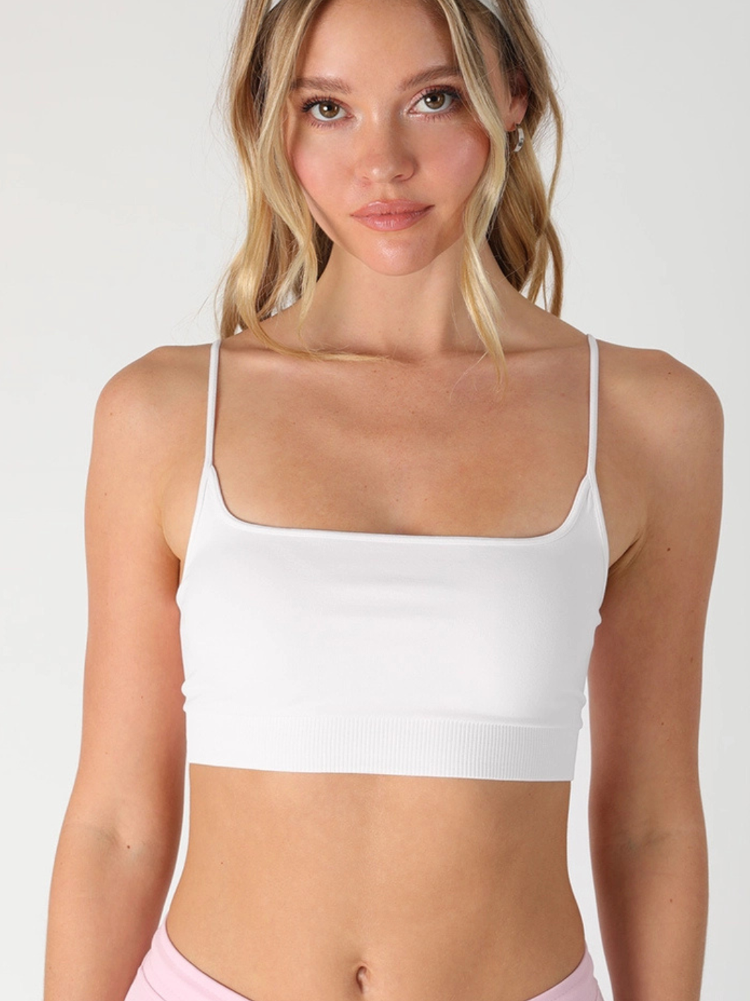 Model wearing The Core Micro Bralette Top in white with a micro square neckline and seamless stretch fabric.