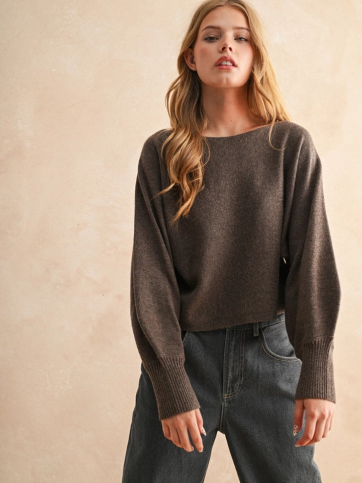 The Ella Cozy Boatneck Sweater on a model in warm brown, mid-weight knit with relaxed, voluminous sleeves.