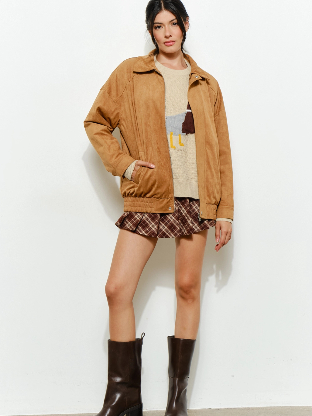 The Halow Vegan Oversized Suede Jacket on a model in camel suede with cream knit sweater and plaid mini skirt.