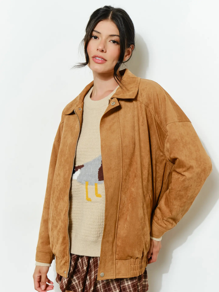 The Halow Vegan Oversized Suede Jacket worn by a model in tan vegan suede with a beige knit sweater.