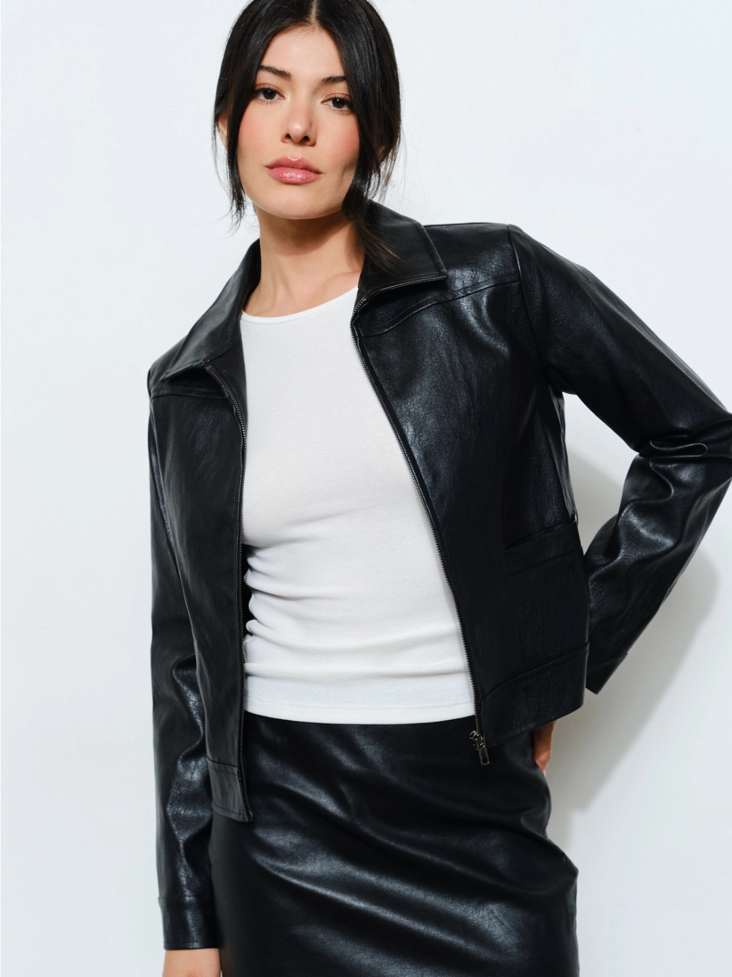 The Nina Vegan Leather Jacket on a model, black vegan leather zip-front outerwear with a classic collar.