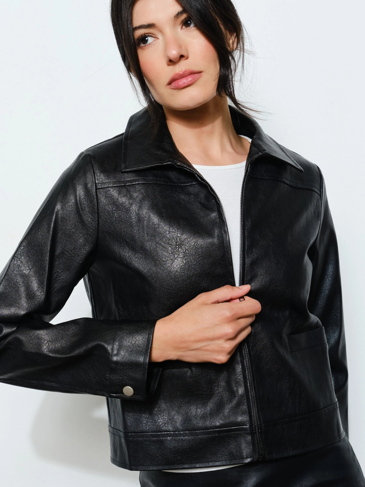 The Nina Vegan Leather Jacket in black with zip-front and collared neckline worn by a model.