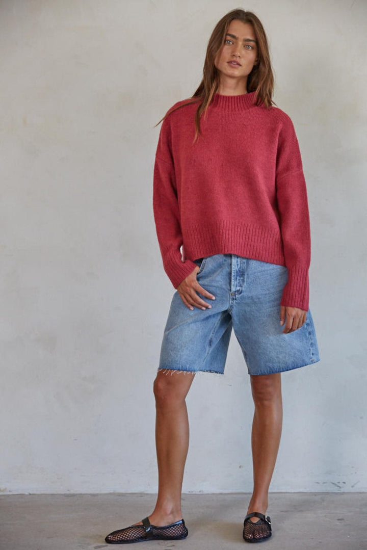 Person standing in sweater and skirt combo