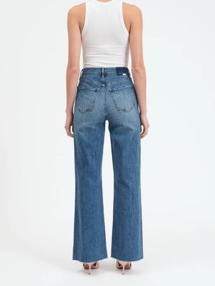 DAZE DENIM Far Out High Rise Wide Leg Jeans, back view of model in blue denim.