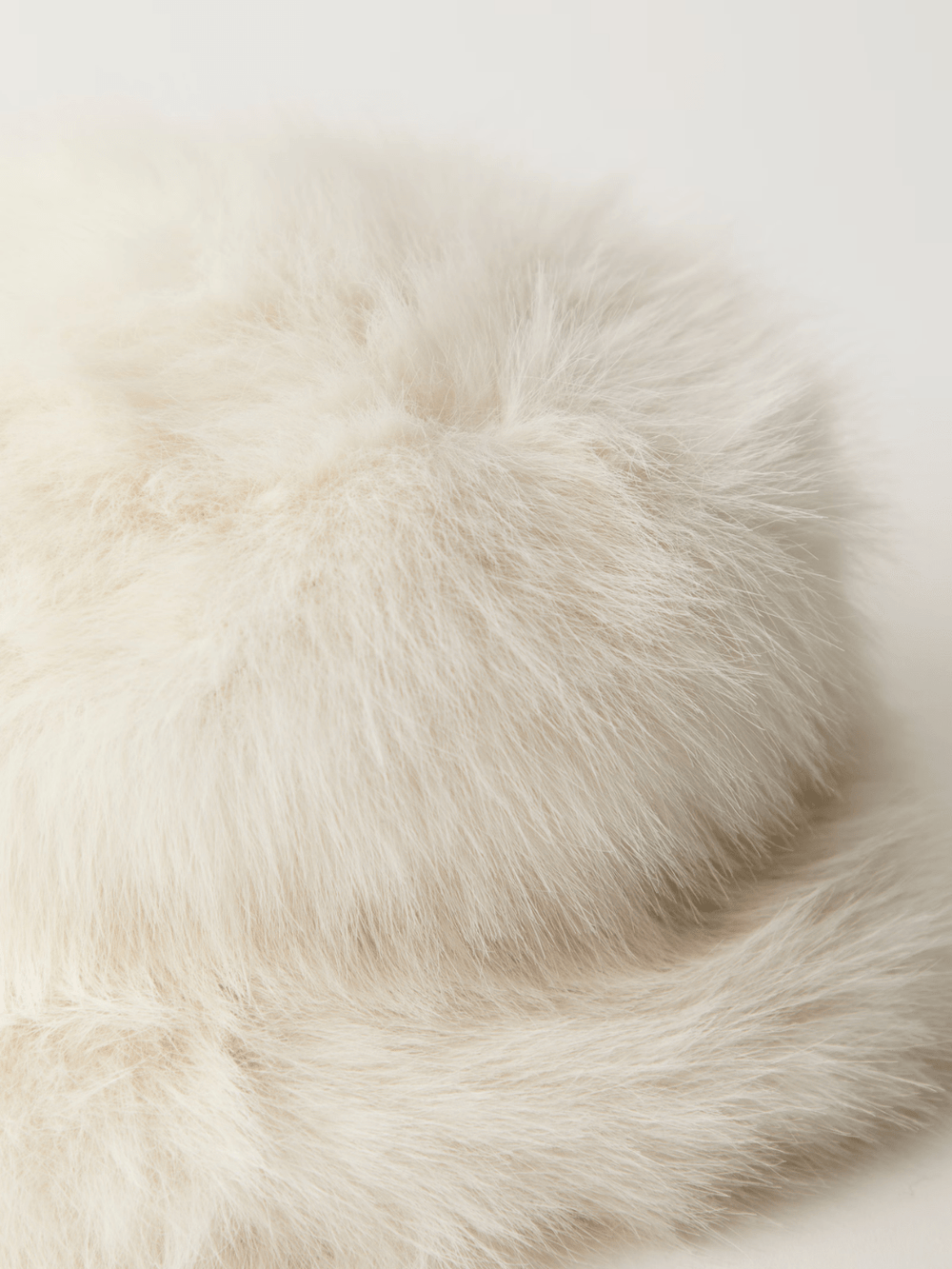 Ice Queen Bucket Hat in cream faux fur, plush and sculpted for warm, statement-making style.