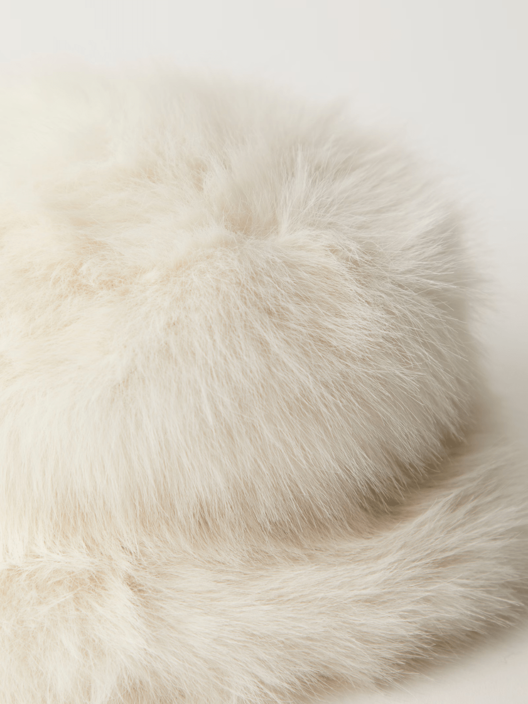 Ice Queen Bucket Hat in cream faux fur, plush and sculpted for warm, statement-making style.