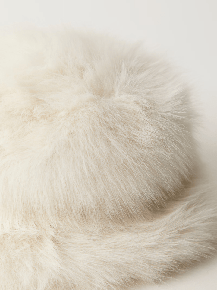 Free People Ice Queen bucket hat in soft ivory faux fur, plush texture close-up.