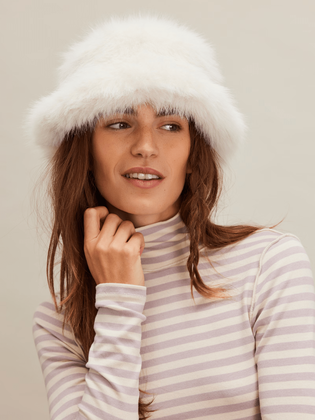 Model wearing FREE PEOPLE Ice Queen Bucket Hat in white faux-fur, plush warmth.