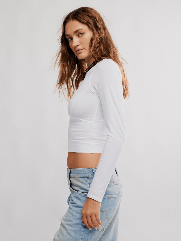 Protagonist Long Sleeve Top by Free People in white, cropped base layer with structured fit and stretch.