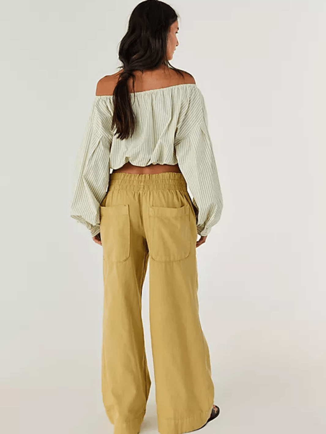 Model in off-shoulder striped top with tan Free People Breezy Denim Pull-On Jeans, wide-leg, mid-rise.