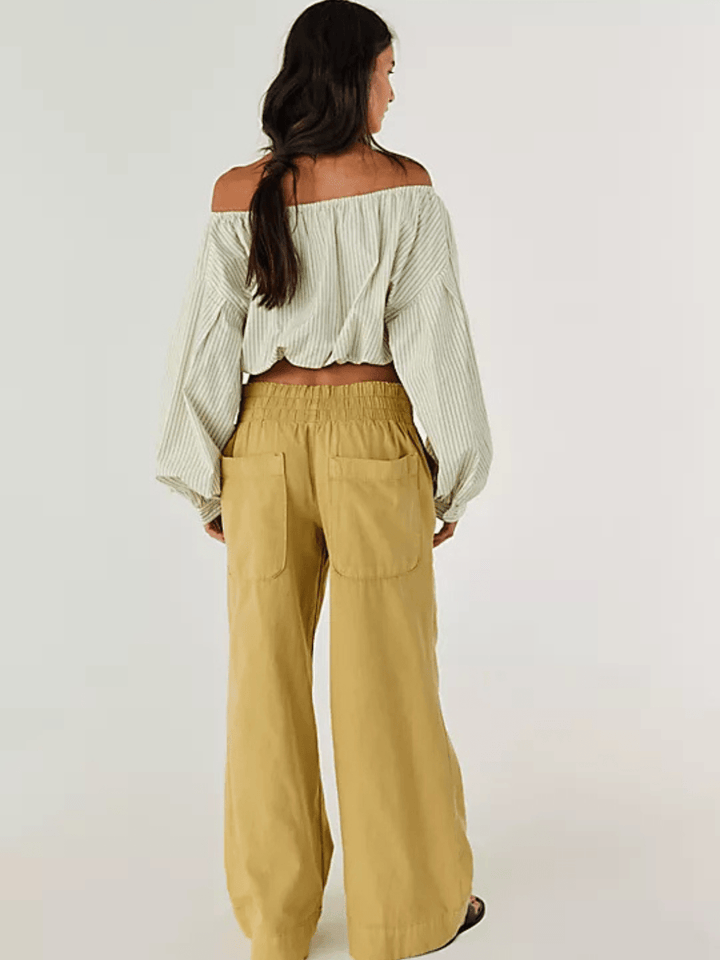 Model in off-shoulder striped top with tan Free People Breezy Denim Pull-On Jeans, wide-leg, mid-rise.