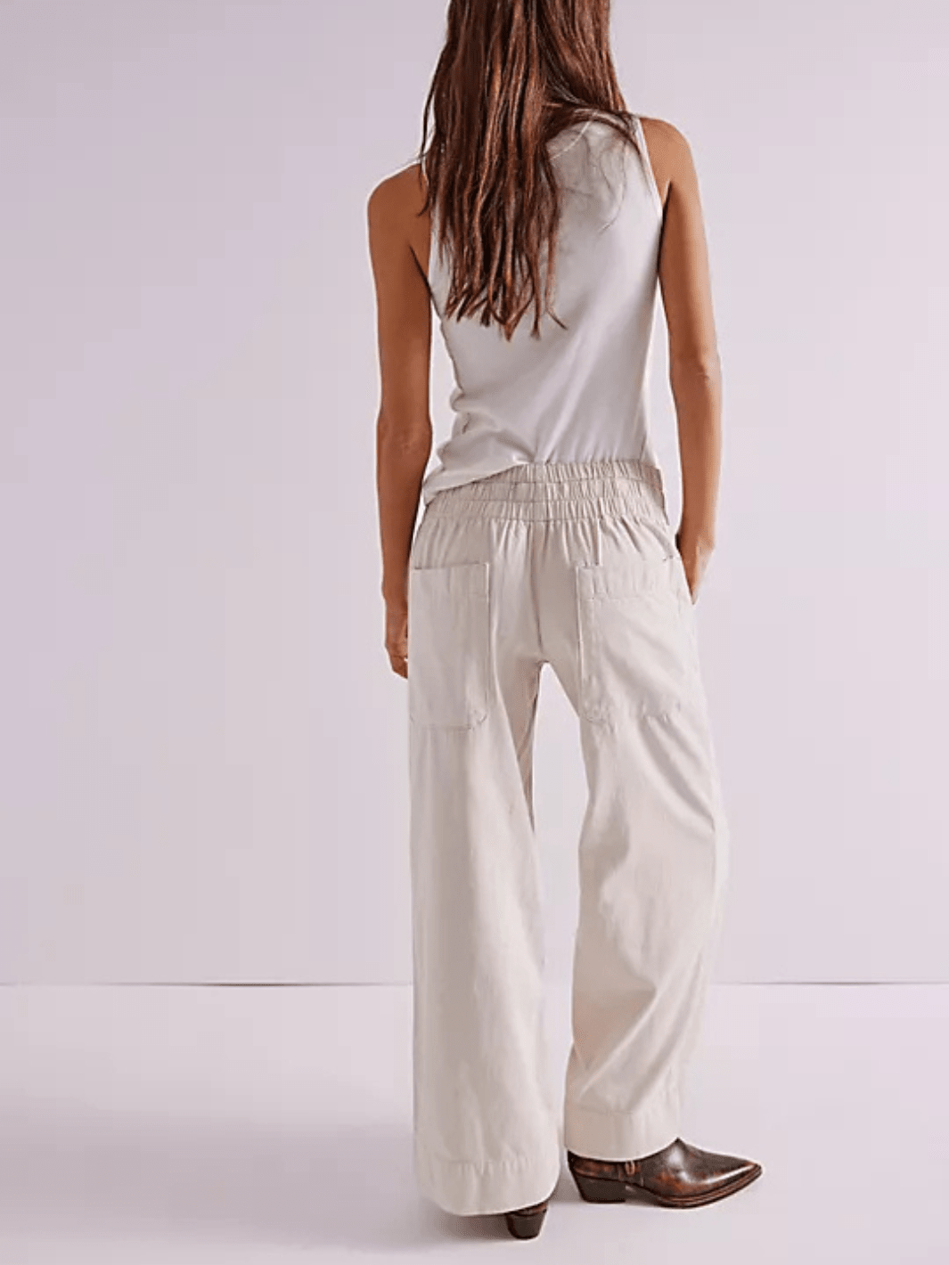 Back view of Free People We The Free Breezy Denim Pull-On Jeans in cream with elastic waist and wide-leg fit.