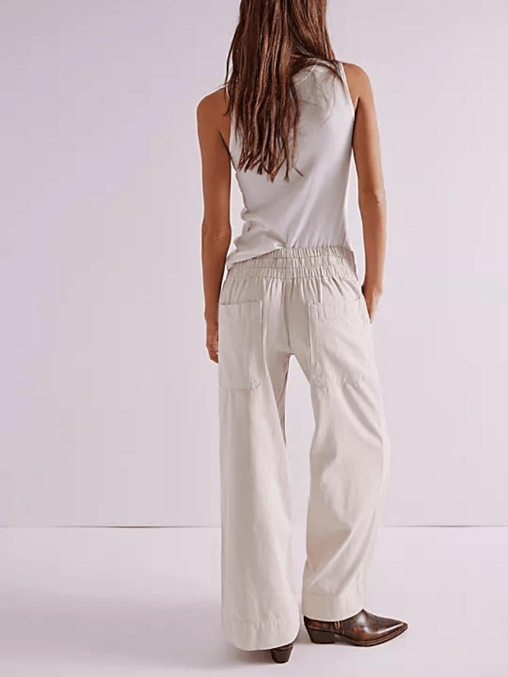 Back view of Free People We The Free Breezy Denim Pull-On Jeans in cream with elastic waist and wide-leg fit.