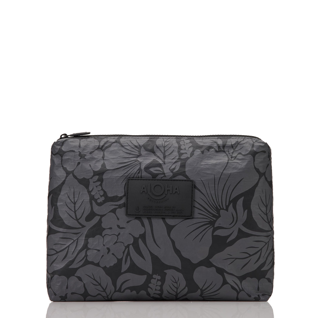 Black Heipua Mid Pouch with a tonal charcoal hibiscus and leaf print, front view with the ALOHA patch